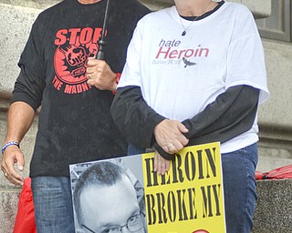 Katie Rickman | The Vindicator.Cindy Anderson of Columbiana holds a poster with a photo of her son Sean O'Connor ODed on heroin, she spoke during the Walk Against Heroin which started at CCA at 1806 Market St and ended at the court house downtown on September 12, 2015. Standing next to her is Fred DiMarco of Cleveland.