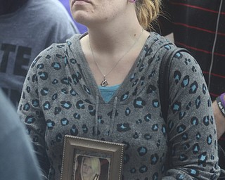 Katie Rickman | The Vindicator.Roxanne Farrow holds a photograph of her sister Gina Wilson who died after overdosing on heroin this year, she attended the Walk Against Heroin which started at CCA at 1806 Market St and ended at the court house downtown on September 12, 2015.