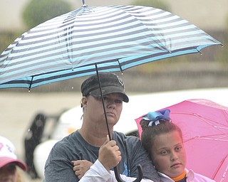 Katie Rickman | The Vindicator.Sonja Witchey (OKAY) and her daughter Jalynn 9 huddle together under an umbrella as they hold a sign of Sonja's sister Tiffany Lovejoy overdosed on heroin in 2015. They attended in the Walk Against Heroin which started at CCA at 1806 Market St and ended at the court house downtown on September 12, 2015.