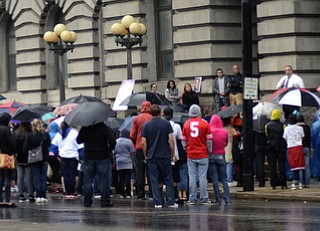 Katie Rickman | The Vindicator.Roughly 100 stand in the rain and listen to Leonard Campanello speak during the Walk Against Heroin which started at CCA at 1806 Market St and ended at the court house downtown on September 12, 2015.