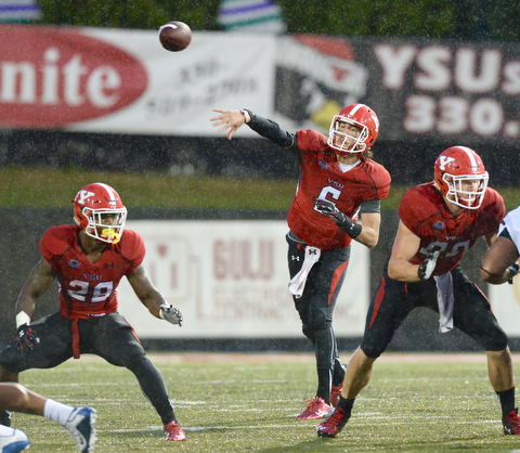 Jeff Lange | The Vindicator  SEPTEMBER 12, 2015 - YSU quarterback Hunter Wells (6) attempts a pass in the pouring rain in the first half of the Penguins' game against RMU, Saturday night in Youngstown.
