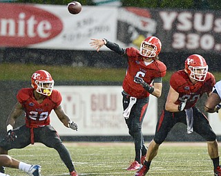 Jeff Lange | The Vindicator  SEPTEMBER 12, 2015 - YSU quarterback Hunter Wells (6) attempts a pass in the pouring rain in the first half of the Penguins' game against RMU, Saturday night in Youngstown.