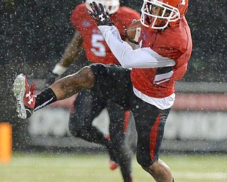 Jeff Lange | The Vindicator  SEPTEMBER 12, 2015 - Andre Stubbs of YSU rushes for yards in the second quarter of Saturday evening's game in the pouring rain against Robert Morris University.