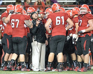 Jeff Lange | The Vindicator  SEPTEMBER 12, 2015 - YSU offensive line coach Carmen Bricillo (facing) strategizes with members of the offensive line during a time out late in the second quarter against Robert Morris University at Stambaugh Stadium, Saturday night.