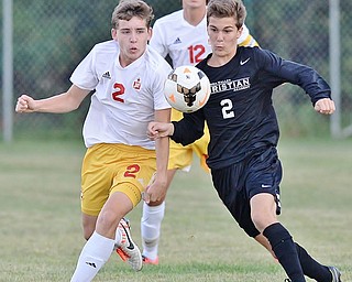 Jeff Lange | The Vindicator  SEPTEMBER 15, 2015 - Mooney's Evan Leek (left) and Jake Ritzel chase down the ball early in the first half of their matchup in Struthers on Tuesday night.