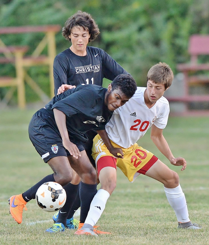 Jeff Lange | The Vindicator  SEPTEMBER 15, 2015 - CVCA's Andrew Akindipe (left), Cody Boerema (top) and Mooney's Christopher Perry battle for the ball during first half action of their game, Tuesday night in Struthers.