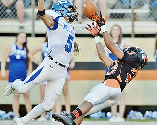 Jeff Lange | The Vindicator  SEPTEMBER 18, 2015 - Howland wide receiver Steve Baugh (right) attempts to make a diving catch against Poland defensive back Tony Chiaro (5) in the first half of Friday night's game in Howland. Poland defeated Howland 24-17.