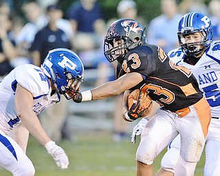 Jeff Lange | The Vindicator  SEPTEMBER 18, 2015 - Howland wide receiver Steve Baugh (23) stiff arms Poland defensive back Tyler Smith (12) as Nick Miller (85) trails the play from behind during first half action of their game Friday night in Howland.
