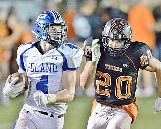 Jeff Lange | The Vindicator  SEPTEMBER 18, 2015 - Poland's Dylan Garver (4) outruns Tigers' Victor Williams (20) in the second quarter of their game Friday night in Howland.
