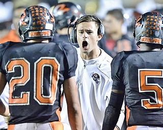 Jeff Lange | The Vindicator  SEPTEMBER 18, 2015 - Howland wide receiver coach Ken Pozega (center) celebrates with players Victor Williams (20) and Tyriq Ellis (5) after a touchdown late in the second quarter of their game against Poland on Friday.