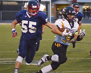 Katie Rickman | The Vindicator.Crestview's Zach Hicks (#34) pushes past JFK's Zach Lewis (#55) during the first half of the game in Warren on Saturday, September 19, 2015.