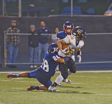 Katie Rickman | The Vindicator.Crestview's Zach Hicks (#34) is unstoppable as JFK's Dominic Campana (#28) during the first half of the game in Warren on Saturday, September 19, 2015.