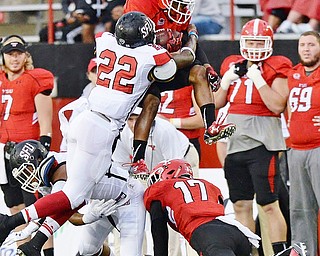 Jeff Lange | The Vindicator  SEPTEMBER 19, 2015 - YSU wide receiver Andre Stubbs leaps over a host of players as SFU's Lorenzo Jerome (22) tackles him during first half action of Saturday's game in Youngstown.