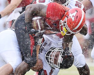 Jeff Lange | The Vindicator  SEPTEMBER 19, 2015 - YSU tailback Martin Ruiz is ripped down to the ground by SFU's Louie Gartner during second quarter action of Saturday afternoon's game in Youngstown.