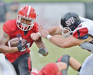 Jeff Lange | The Vindicator  SEPTEMBER 19, 2015 - Jody Webb (let) is shoved out of bounds by SFU's Zane Stewart in the second quarter of Saturday's game in Youngstown.