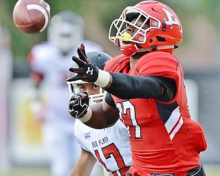Jeff Lange | The Vindicator  SEPTEMBER 19, 2015 - Isiah Scott wide receiver for YSU reaches out for a pass thrown just out of reach as Red Flash's Malik Duncan trails the play from behind during third quarter action of Saturday's game in Youngstown.