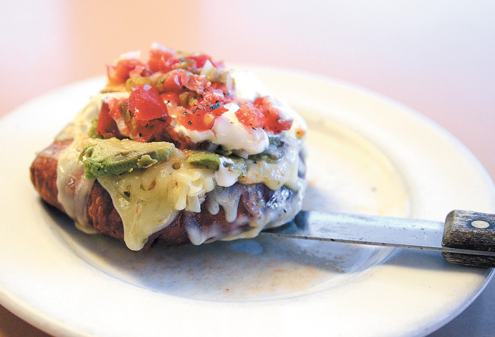 The "Fiesta Burger" at Just Fred's features 1/2 lbs taco seasoned burger wrapped in fried tortilla and topped with sour cream, pepperjack, lettuce, guacamole and homemade pico de gallo.