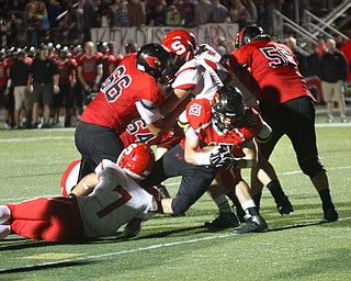       .         ROBERT  K. YOSAY | THE VINDICATOR..Canfield #47 C J Frost goes in for a score asStruthers #7 Dakota Senvisky does his best to stop him during third quarter action..struthers at canfied. -30-
