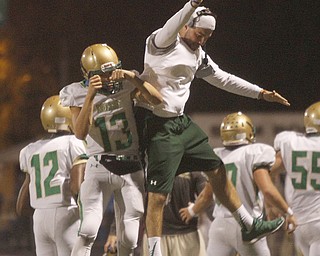       .         ROBERT  K. YOSAY | THE VINDICATOR..Warren Harding vs Ursuline at Harding..Ursulines #13   Jared Fabry  celebrates with a coach after scoring a touchdown to put the irish up by three touchdowns ...-30-