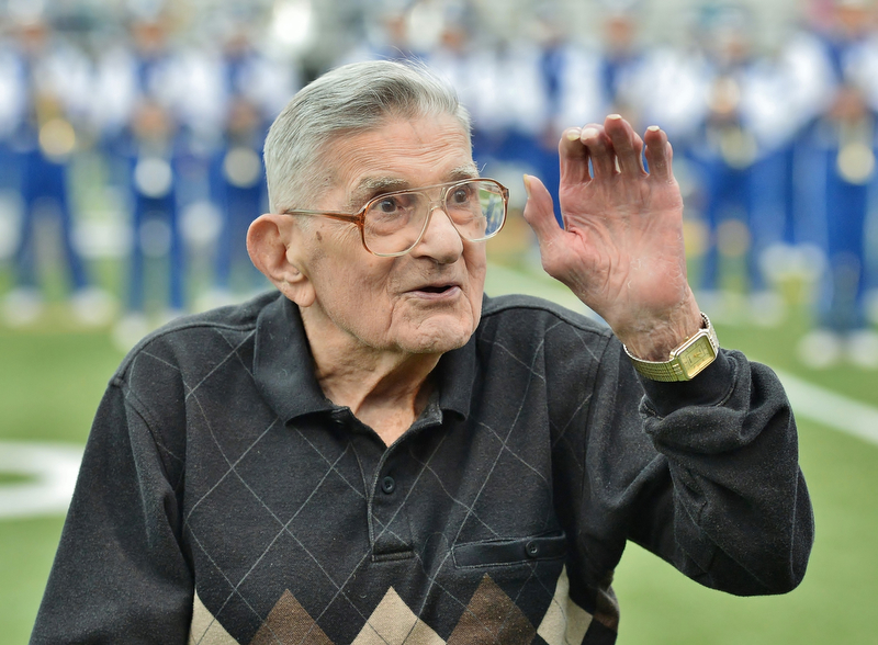 Jeff Lange | The Vindicator  SEPTEMBER 25, 2015 - Former Hubbard class of 1943 football player Dan Williams waves to the crowd prior to the start of Hubbard's homecoming game against Howland.