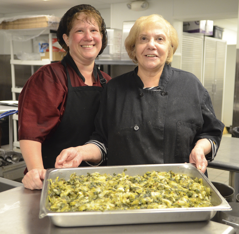 Katie Rickman | The Vindicator.The family aspect of The Italian Marketplace runs strong as all members of the family have a hand in the business. Here, Tracy Marshall, owner Bobby DeVicchio's sister, and Nancy Doumount, Bobby and Tracy's mom, show their "famed" greens, which are hot sellers at the new Niles store.