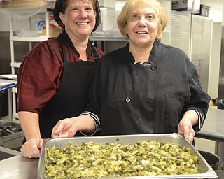Katie Rickman | The Vindicator.The family aspect of The Italian Marketplace runs strong as all members of the family have a hand in the business, see here is Tracy Marshall (sister of owners) and Nancy Doumount (mother of Bobby DeVicchio) hold their "famed" greens that are hot sellers at the store in Niles on September 21, 2015.
