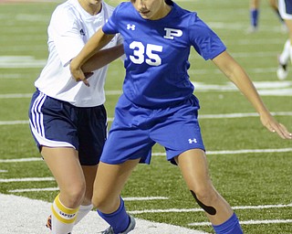 Katie Rickman | The Vindicator.Poland's Marissa Melillo (#35) gains control of the ball and holds back Niles (#22) during the second half of the game on Monday September 28, 2015.