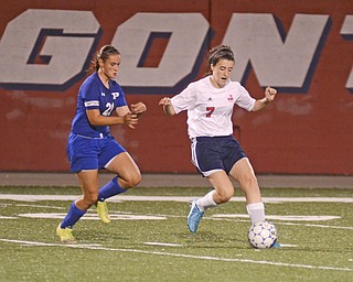 Katie Rickman | The Vindicator.Niles  Aundrea Scattino (#7) moves up field as Poland's Jessica Miller (#21) trails behind during the first half of the game on Monday September 28, 2015.