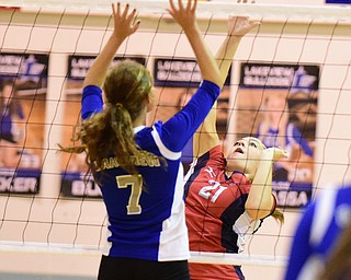 CORTLAND, OHIO - SEPTEMBER 29, 2015: Natalie Lynn #21 of Fitch jumps to strike the ball while Carly Casassa #7 of Lakeview leaps for the block during their game Tuesday night at Lakeview High School. DAVID DERMER | THE VINDICATOR