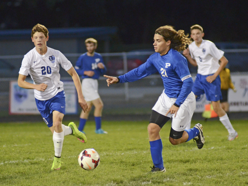 Katie Rickman | The Vindicator.Poland's  team captain Jake Buccieri (#21) points while looking for an open pass as Lakeview's  Josh Kelley (#20) attempts to block him.
