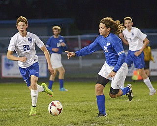 Katie Rickman | The Vindicator.Poland's  team captain Jake Buccieri (#21) points while looking for an open pass as Lakeview's  Josh Kelley (#20) attempts to block him.