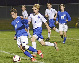 Katie Rickman | The Vindicator.Poland's Trey Medvec (#11) pushes down center field as Lakeview's Chris Altier (#5) follows close behind during the first half of the game at Lakeview High School on October 1, 2015.