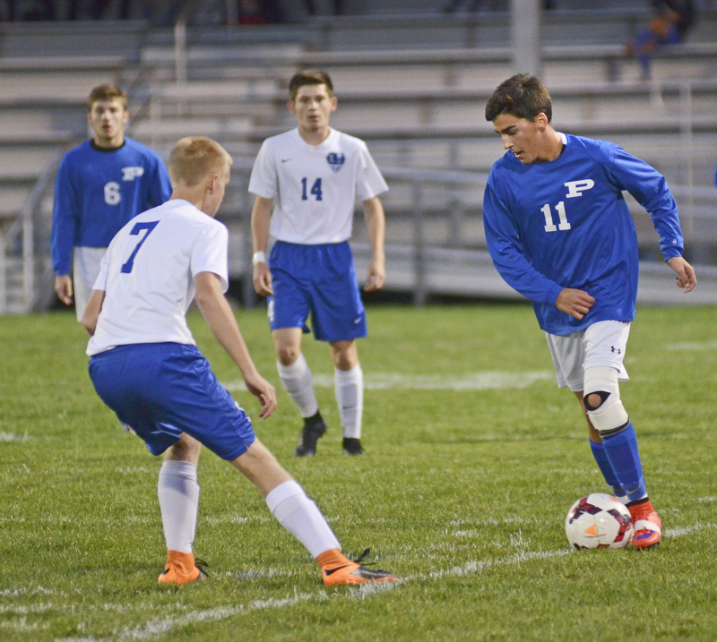 Katie Rickman | The Vindicator.Poland's Trey Medvec (#11) is blocked by Lakeview's  Zac White(#7) during the first half of the game at Lakeview High School on October 1, 2015.