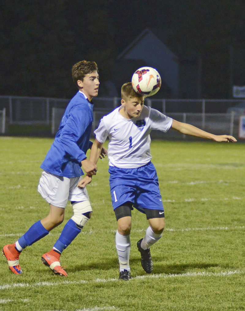 Katie Rickman | The Vindicator.Lakeview's Anthony Sylvester (#1) head butts the ball as  Poland's Trey Medvec (#11) attempts to gain control of the ball during the first half of the game at Lakeview High School on October 1, 2015.
