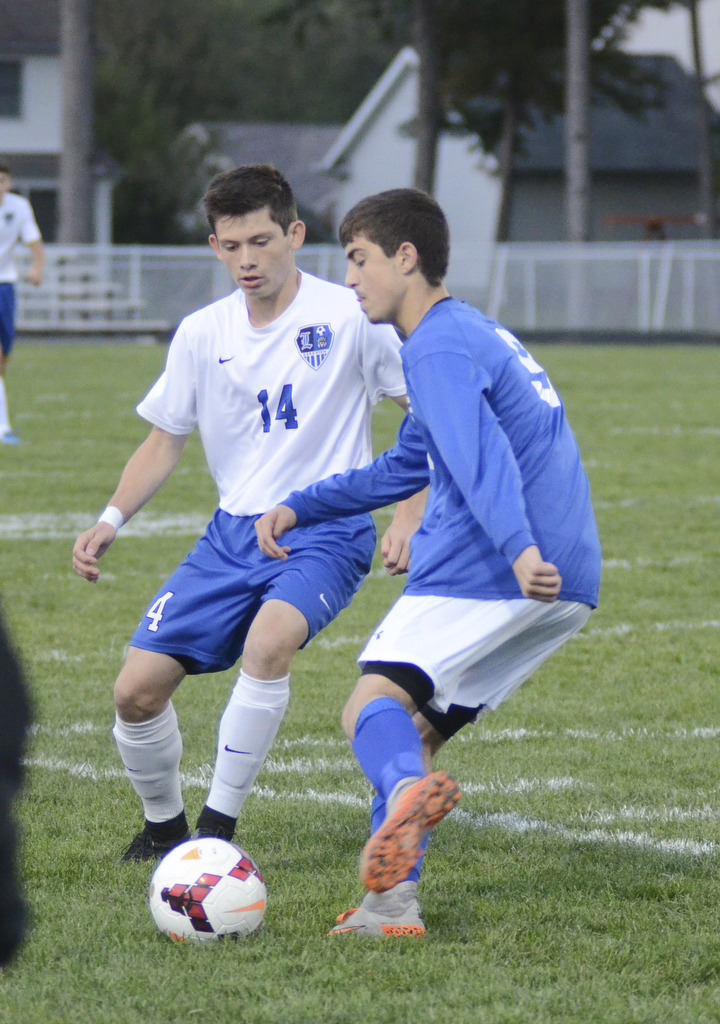 Katie Rickman | The Vindicator..Poland's  Ryan Weitzman (#9) moves down field and pushes past Lakeview's Daniel Sarko (#14)during the first half of the game at Lakeview High School on October 1, 2015.