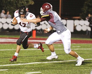        ROBERT K. YOSAY  | THE VINDICATOR..Canfields  #47 CJ Frost  gets pulled down for a loss by Boardmans #75 Acevedo Jordan for a loss during third quarter action deep in their own territory.Canfield vs Boardman @ Boardman .