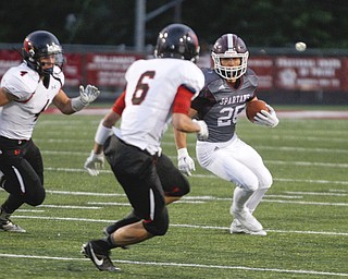        ROBERT K. YOSAY  | THE VINDICATOR..Boardmans #25 Mario Graziani breaks around end for a first down during first quarter action Canfields #6  Michael Rusu  made the stop during first quarter action..Canfield vs Boardman @ Boardman .