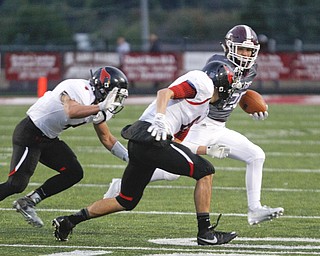        ROBERT K. YOSAY  | THE VINDICATOR..Boardmans #25 Mario Graziani breaks around end for a first down during first quarter action Canfields #6  Michael Rusu and #4 Paul Breinz are in pursuit.. driving him out of bounds  .Canfield vs Boardman @ Boardman .