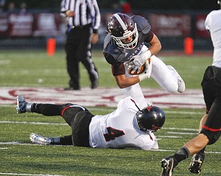        ROBERT K. YOSAY  | THE VINDICATOR..Canfield vs Boardman @ Boardman ..Boardmans #9 Gaven Strines tries to break a tackle by Canfield #4 Paul Breinz during first quarter action