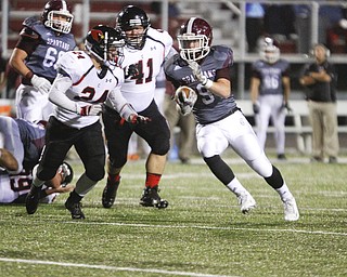        ROBERT K. YOSAY  | THE VINDICATOR..Boardmans  #9 Gaven Strines  races past canfields #24  Angelo Petracci and #41  Collin FIshel  for a few yards during second quarter action..Canfield vs Boardman @ Boardman .