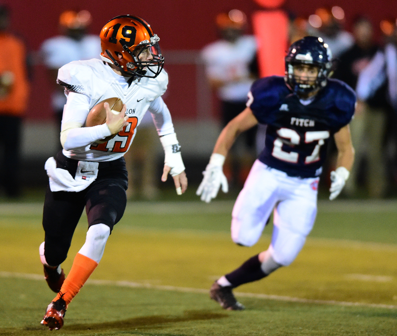 AUSTINTOWN, OHIO - OCTOBER 2, 2015: Lee Hurst II runs with the football while avoiding backside pressure from Zach Krohn #27 of Fitch during their game Friday night at Fitch Falcons Stadium. DAVID DERMER | THE VINDICATOR
