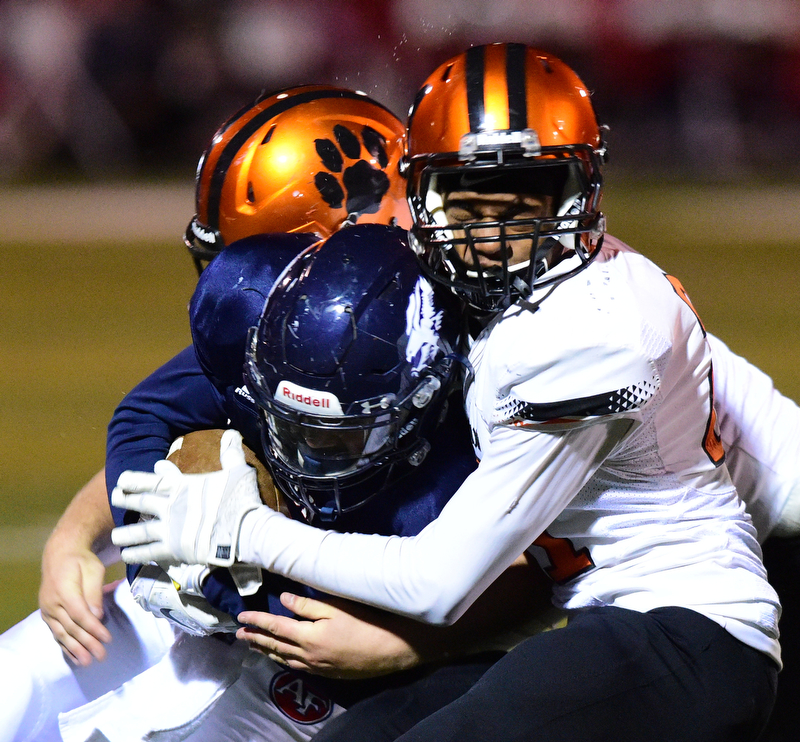 AUSTINTOWN, OHIO - OCTOBER 2, 2015: Randy Smith #25 of Fitch is brought down by Anthony Ballard #21 of Massillon during their game Friday night at Fitch Falcons Stadium. DAVID DERMER | THE VINDICATOR