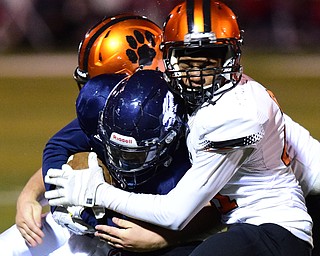 AUSTINTOWN, OHIO - OCTOBER 2, 2015: Randy Smith #25 of Fitch is brought down by Anthony Ballard #21 of Massillon during their game Friday night at Fitch Falcons Stadium. DAVID DERMER | THE VINDICATOR