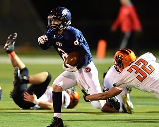 AUSTINTOWN, OHIO - OCTOBER 2, 2015: Nate Fowler #8 of Fitch runs the football away from the arm tackle of Kordell Ford #32 of Massillon during their game Friday night at Fitch Falcons Stadium. DAVID DERMER | THE VINDICATOR