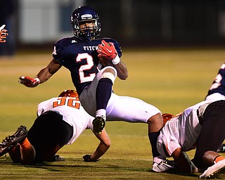 AUSTINTOWN, OHIO - OCTOBER 2, 2015: Jakari Lumsden #24 of Fitch spins out of a tackle from Jamir Thomas #16 and Kordell Ford #24 of Massillon during their game Friday night at Fitch Falcons Stadium. DAVID DERMER | THE VINDICATOR