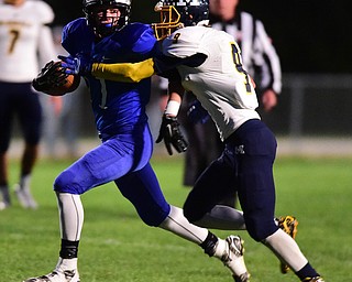 NORTH JACkSON, OHIO - OCTOBER 2, 2015: Noah Laster #11 of Jackson Milton runs with the football while Jake Reckard #9 of McDonald attempts to bring him down during the 1st half of their game at Jackson Milton Stadium Friday night. DAVID DERMER | THE VINDICATOR