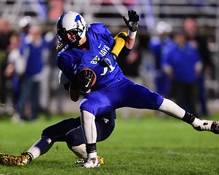 NORTH JACkSON, OHIO - OCTOBER 2, 2015: Noah Laster #11 of Jackson Milton is brought down by Jake Reckard #9 of McDonald after a big gain during the 1st half of their game at Jackson Milton Stadium Friday night. DAVID DERMER | THE VINDICATOR