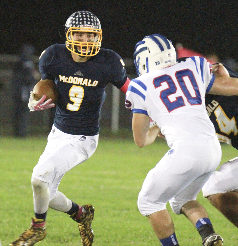 William D Lewis the Vindicator WR's McDonald's Jake Rekard(9)  runs past Western Reserve's Brian Benyo(20) during 1rst half action in McDonald 10-9-15.