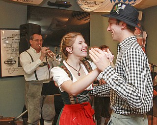 William D Lewis the Vindicator Auggie Heschmeyer and his sister D'Ella Heschmeyer of Liberty dance to German music at Kravitz Deli in Liberty Friday as part of Oktoberfest event.