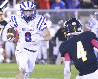 William D Lewis the Vindicator WR's Jeep DiCioccio(9) eludes McDonald's Joey Celli(4) during 1rst half action in McDonald 10-9-15.